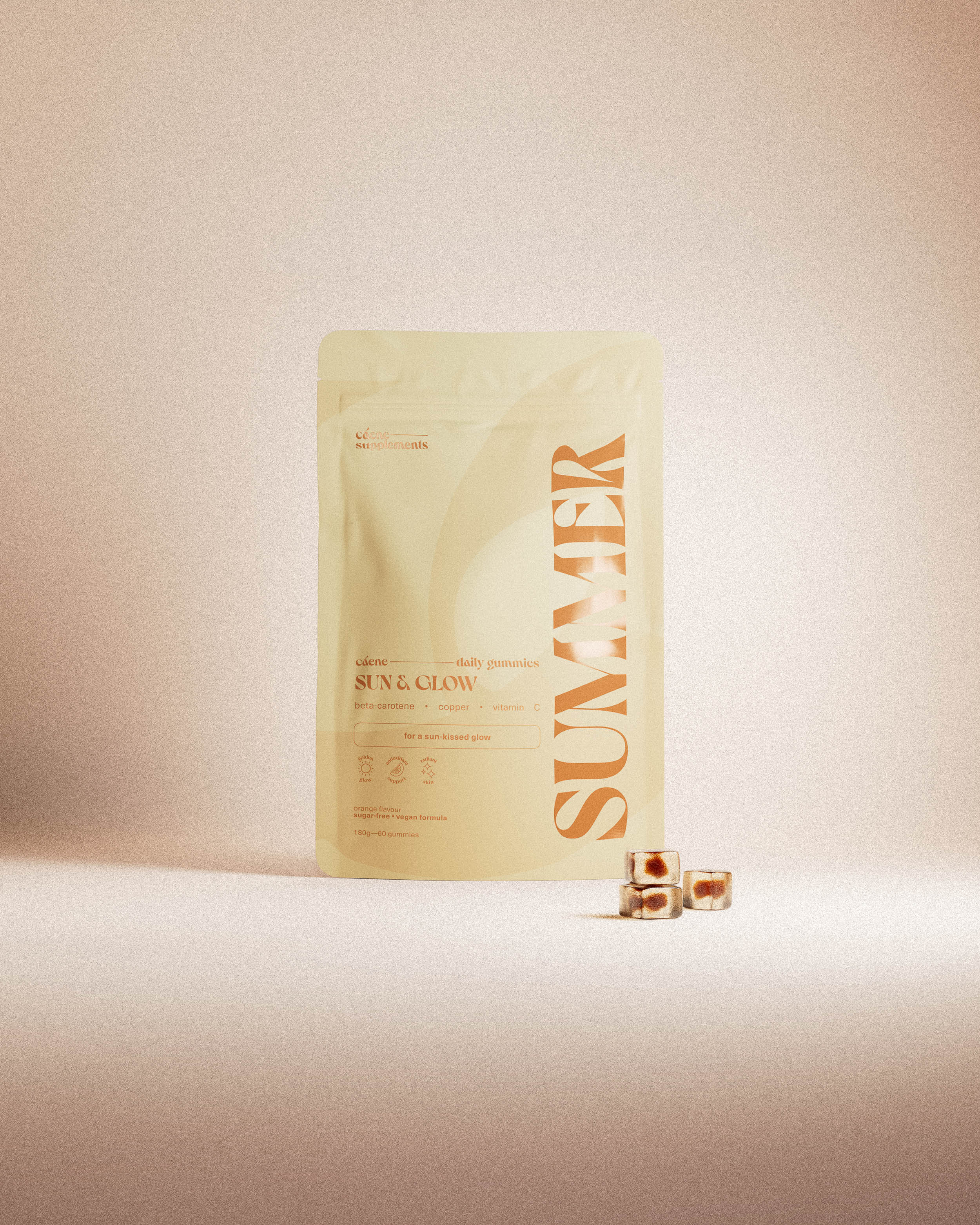 summer gummies pouch with three orange gummies in a warm studio setting